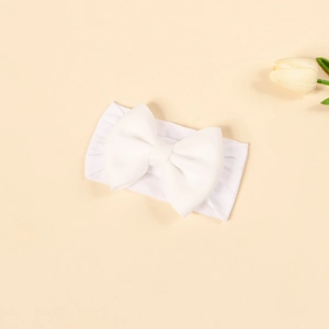 Detail of white nylon baby headband featuring a soft elastic band and a large 3D bow accent