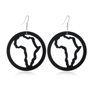 Close-up of black cutout wooden earrings featuring a detailed African map silhouette