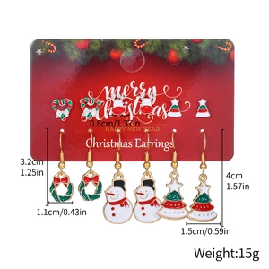 6 pairs of Christmas earrings set with snowman and reindeer designs on a gift card