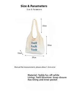 Detail view of plush tote bag with luck embroidery showing dimensions and snap closure