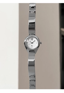 Macro shot of silver stainless steel bangle watch with Roman numeral XII and Gedi logo