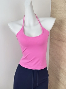 Detailed close-up of a pink halter neck crop top with knitted elastic fabric on a mannequin