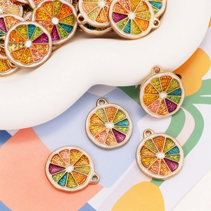 Macro shot of colorful enamel lemon slice pendants with gold trim for DIY jewelry