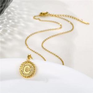 Elegant gold stainless steel necklace with round letter C pendant on white background