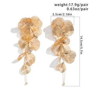 Detailed view of long gold floral earrings with woven petals and size specifications