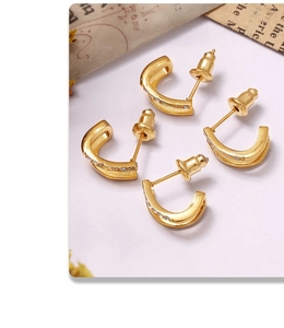 Detail shot of gold-plated double-layer C-shaped earrings with inlaid rhinestones