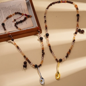 Ethnic beaded necklace with wooden beads and a small vintage spoon pendant accessory