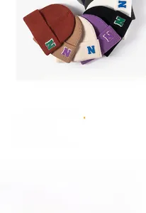 Detailed view of the ribbed knit texture and embroidered letter N on the beanie cuff