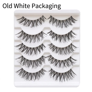 Close-up of five pairs of natural cross false eyelashes in white packaging tray