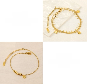 Detail showing 18K engraved stamp on heart and pearl gold plated stainless steel bracelets