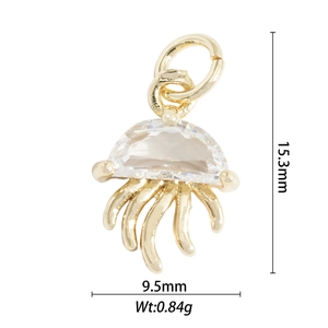 Macro shot of gold jellyfish charm with clear gemstone and product dimensions