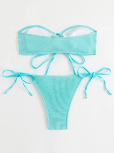 Detailed view of light blue ribbed fabric bikini with bandeau top and side-tie bottoms