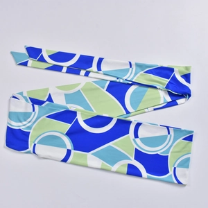 Detail of blue and green geometric circle print on smooth fabric scarf accessory