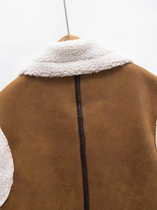 Detail of brown faux suede vest with white fleece collar and leather piping on back