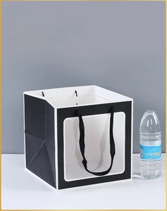 Close-up of square black gift paper bag with white trim and transparent clear window