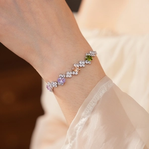 Macro shot of silver bracelet featuring multicolored zircon stones and delicate pavé details