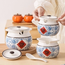 Close-up of blue and white ceramic egg storage jar set with decorative red labels