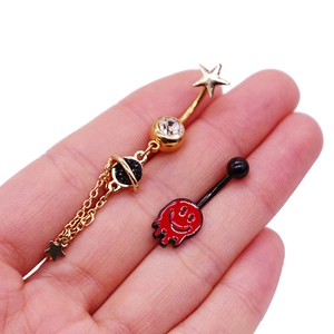 Vue détaillée de piercings de nombril avec étoile dorée et pendentif visage fondu