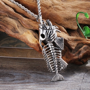 Vintage silver fishbone pendant necklace with twisted chain on rustic wood background