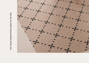 Close-up of vintage French brown carpet with black geometric patterns and woven texture