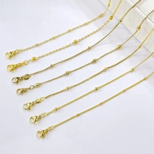 Detail of 18k gold plated chains showing lobster clasp and various textured links