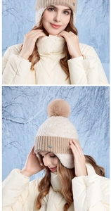 Detail of warm winter knit beanie featuring ear protection and a soft plush pompom