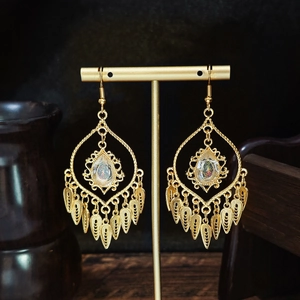 Bohemian gold tassel drop earrings with teardrop gemstone and intricate filigree design