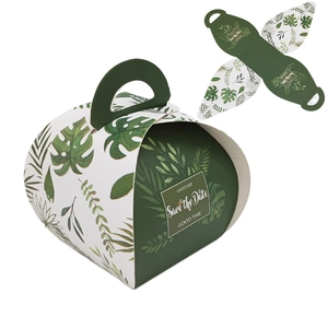 Close-up of European style bread-shaped gift box with green tropical leaf patterns