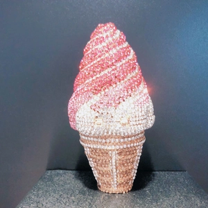 Macro detail of ice cream clutch with pink and cream rhinestones on metal frame