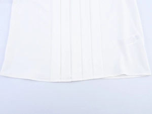 Close-up of vertical pleated hem on a white elegant chiffon blouse for women