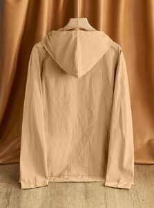 Detail of khaki cotton linen hooded shirt showing natural texture and hanging fit