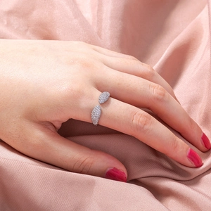 Elegant adjustable silver ring featuring sparkling zircon leaf designs on pink silk backdrop