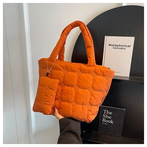 Detail of bright orange quilted tote bag set with matching small lanyard pouch accessory