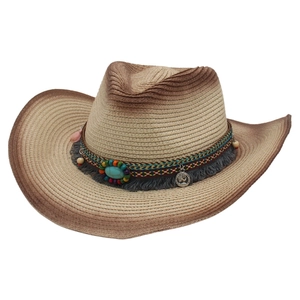 Detail of woven straw cowboy hat featuring ethnic beads, turquoise, and tassel trim