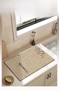 Kitchen scene with a beige faux linen dish drying mat and its detailed woven texture
