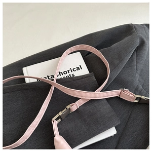 Detail of pink PU leather handbag strap featuring a premium silver metal buckle and sewing