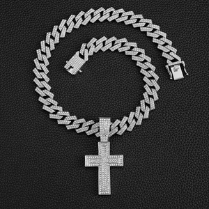 Detail of silver Cuban link necklace with iced-out cross pendant and secure square clasp