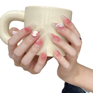 Handmade pink gradient press-on nails with 3D bunny and peach charms long coffin shape