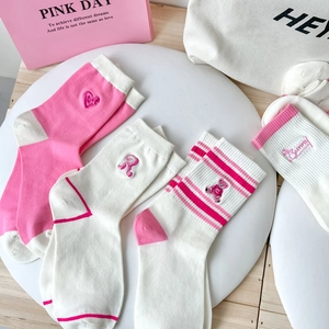 Detail showing pink and white striped cotton socks with cute bear embroidery and heart patterns