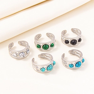 Detailed view of adjustable bohemian rings with turquoise and marble inlays on silk