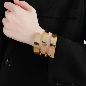 Polished gold multi-layer spiral cuff bracelet with a minimalist mirror finish