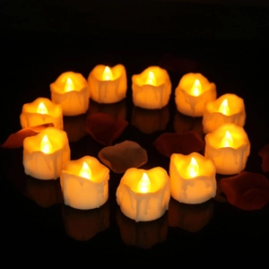 Detailed view of 12 LED tea lights in a heart shape with warm yellow glow and rose petals