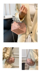 Detail view of pink geometric tote bag with silver chain strap worn by a model