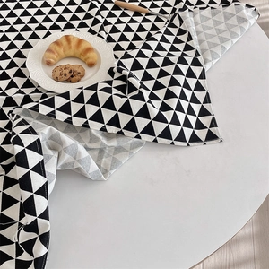 Detailed view of black and white geometric triangle pattern on thick linen tablecloth