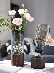 Detail view of the cylinder glass vase with a dark wooden base and gray gradient finish
