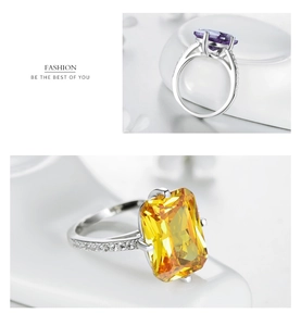Macro shot of emerald cut purple and yellow zircon rings with paved side stones