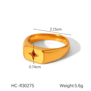 Detail shot of a gold-plated eight-pointed star ring with a red gemstone and dimensions