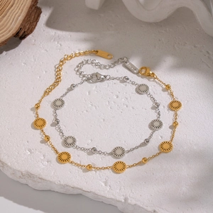 Minimalist 18K gold and silver stainless steel sun disk bracelets on marble background