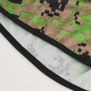 Detailed view of digital camouflage fabric with reinforced black stitched edge for durability