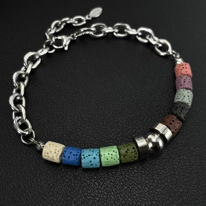 Macro detail of colorful volcanic stone beads and silver titanium steel chain bracelet